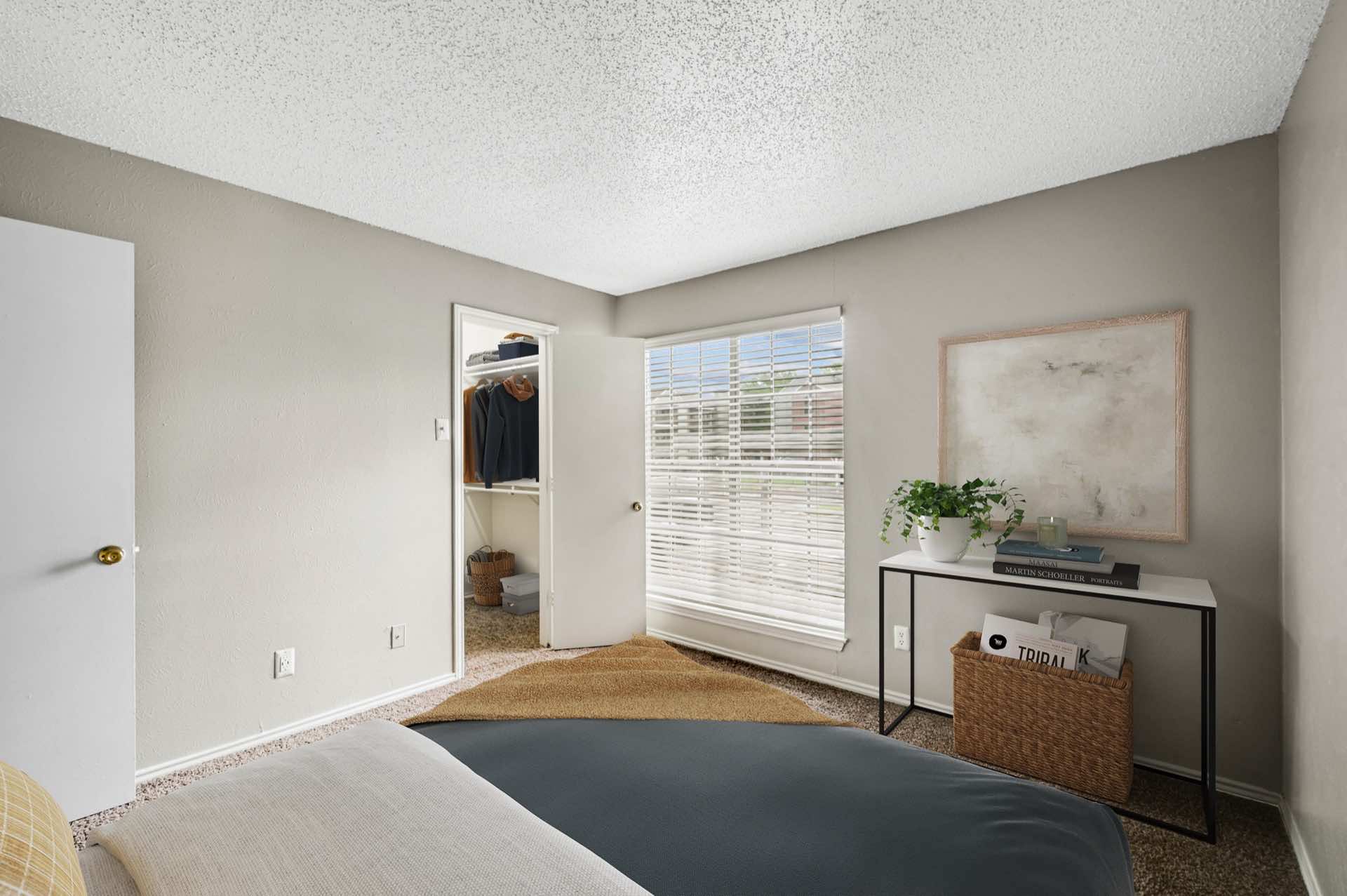 Bedroom with walk-in closet and large window
