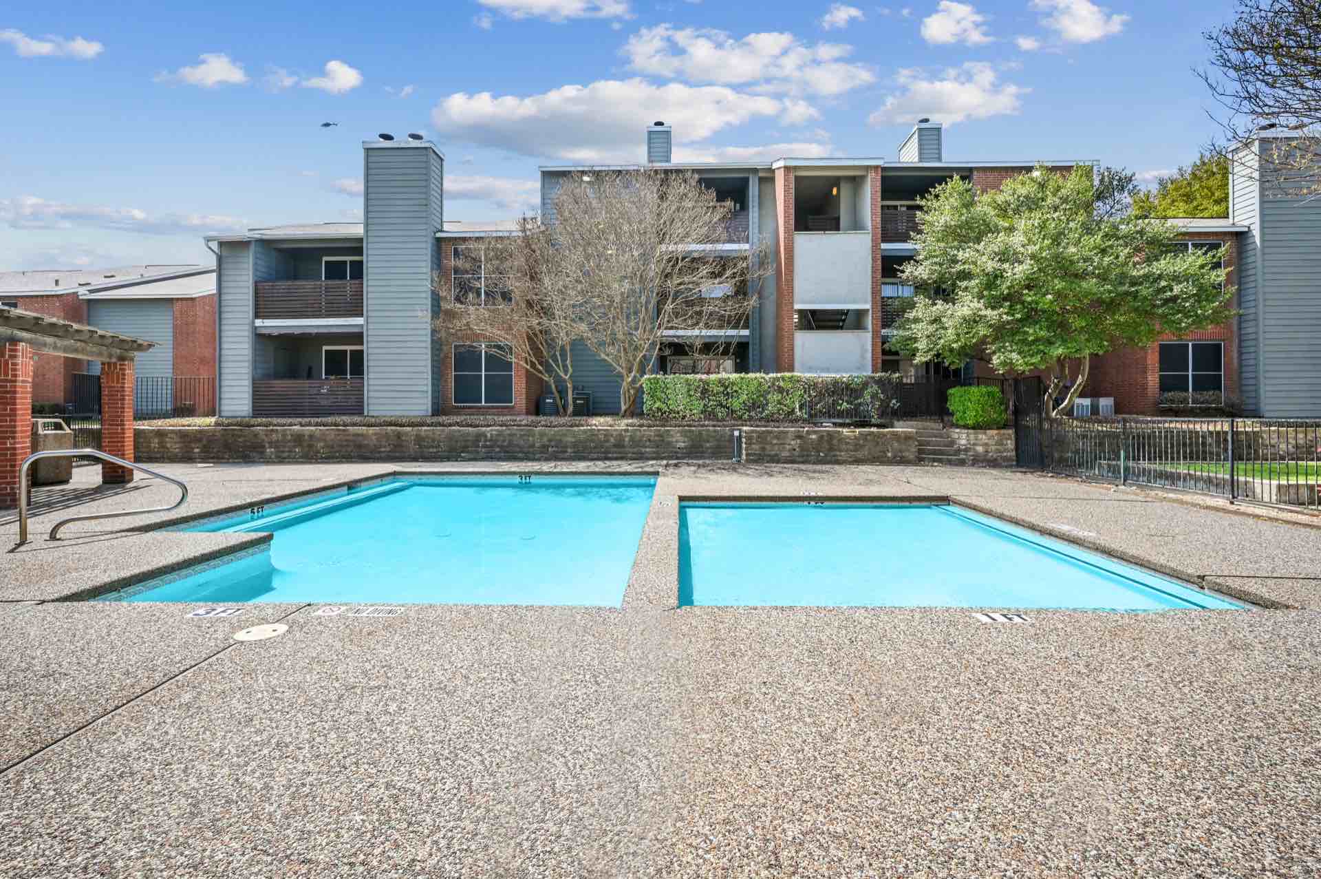 Two smaller pools by apartment buildings