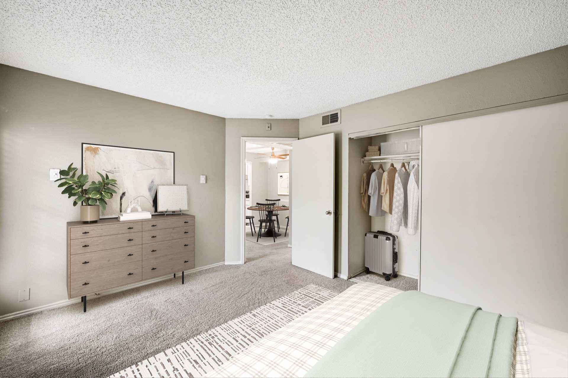 Carpeted bedroom with reach-in closet