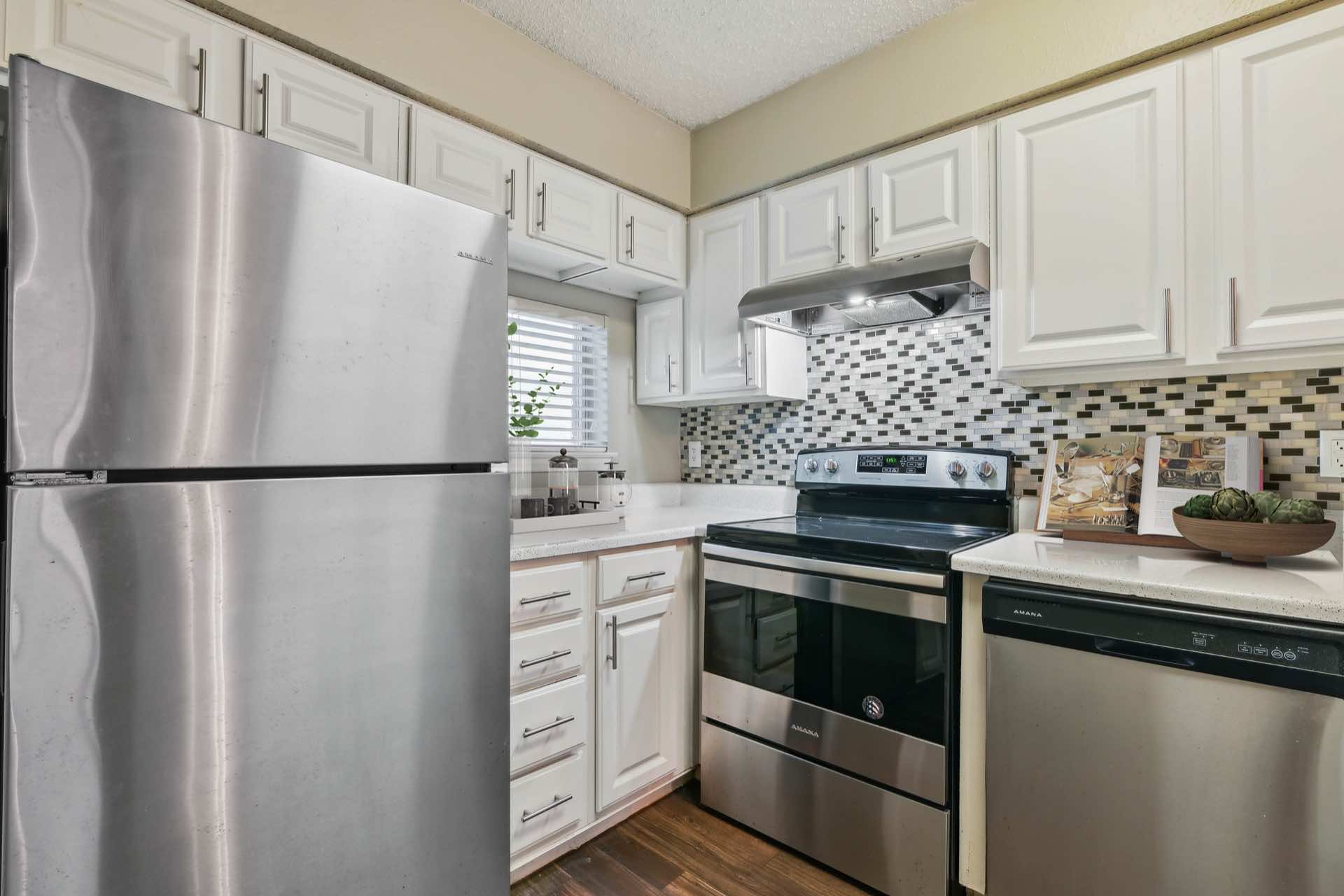 Kitchen with tile backsplash and stainless steel appliances