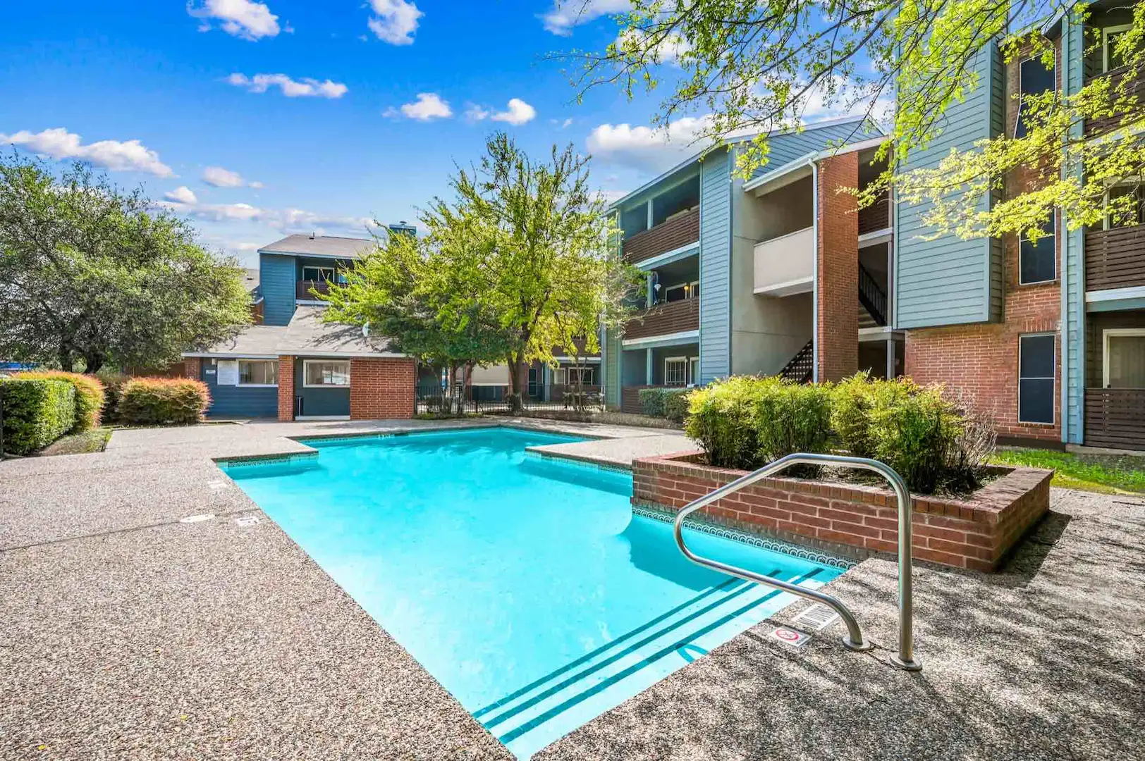 pool with deck and surrounding landscaping